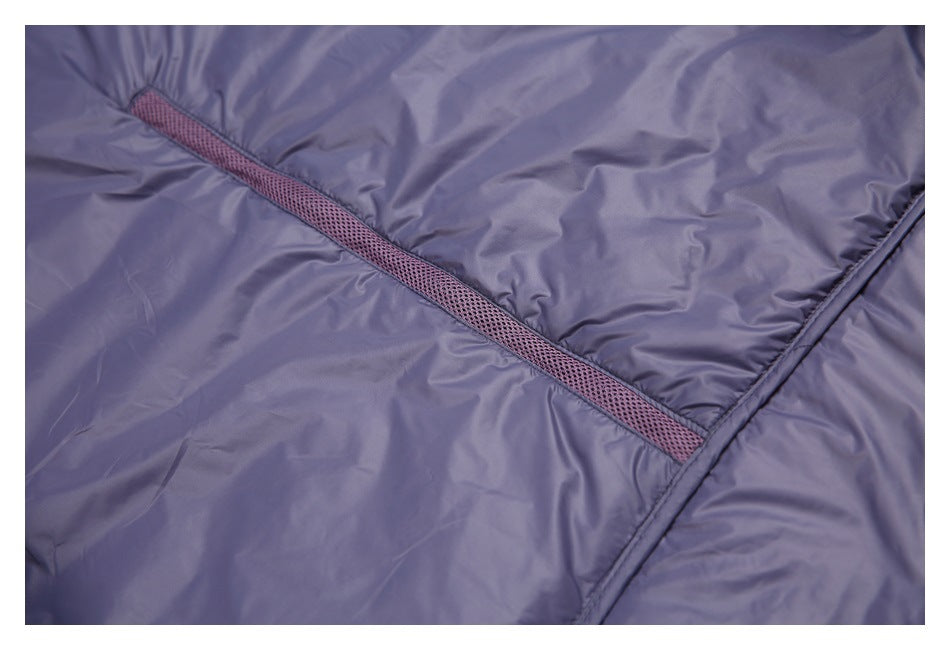 Close-up of a diagonal mauve mesh-trimmed opening on shiny lavender-gray fabric.