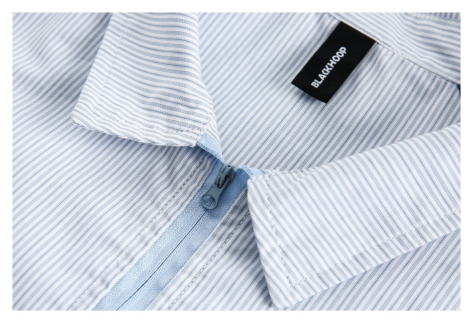 Close-up of the striped shirt collar, blue zipper, and BLACKHOOP neck label.