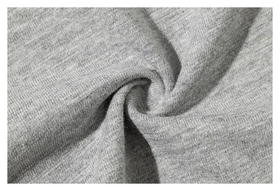 Macro view of the heather gray T-shirt's knit surface gathered into folds.
