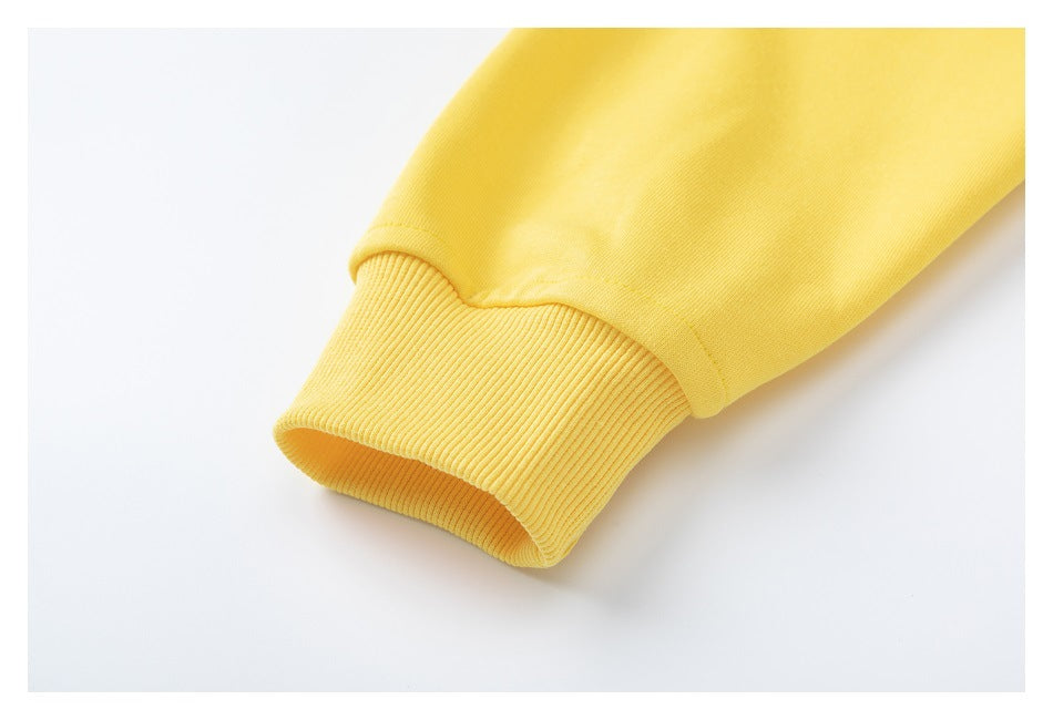 Close-up of a yellow sweatshirt sleeve ending in a wide ribbed cuff.