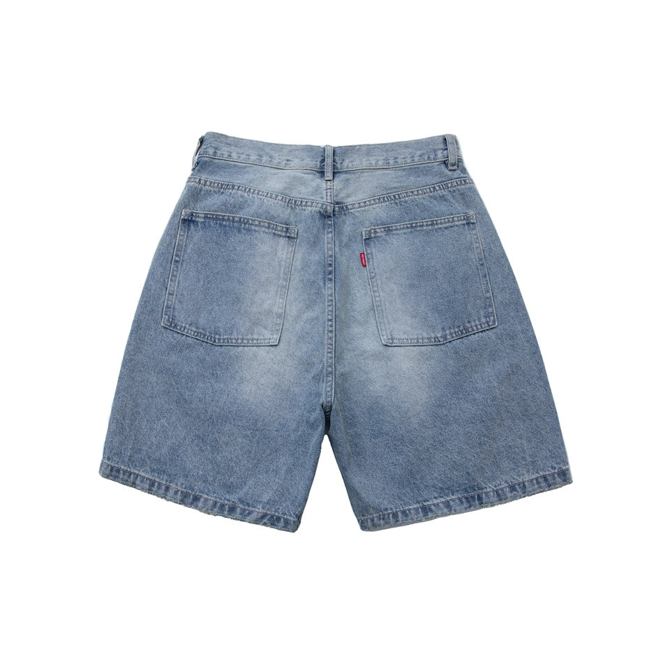 Back view of light blue washed denim shorts with two patch pockets and a small red tab