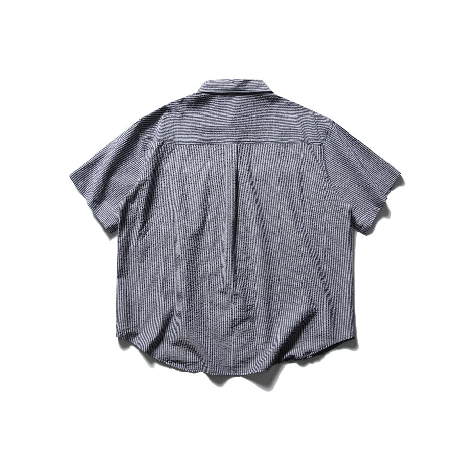 Back view of navy and white striped short-sleeve shirt with back yoke and center pleat