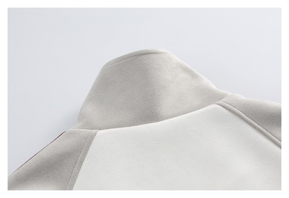 Close-up of a light gray garment's raised collar and stitched shoulder seams.