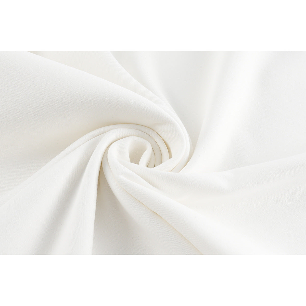 Close-up of white fabric arranged in a spiral to show its surface and drape.