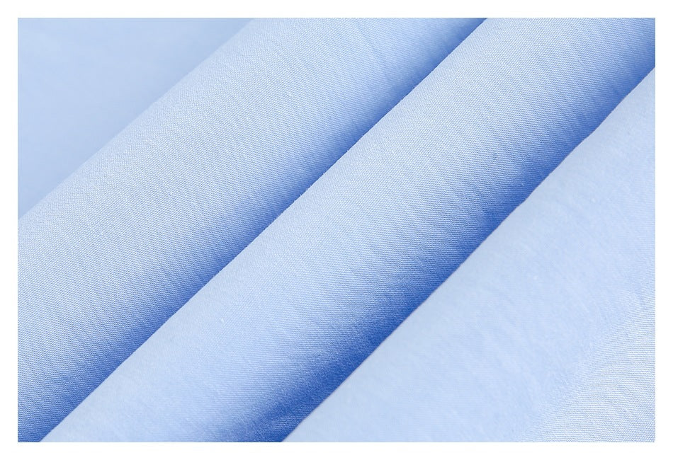 Close-up of pale blue fabric folded into soft diagonal ridges.