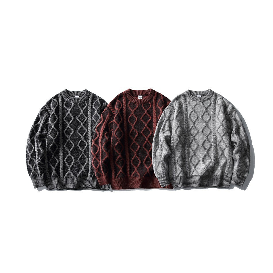 Three crewneck cable-knit sweaters shown from the front in charcoal, burgundy, and gray.