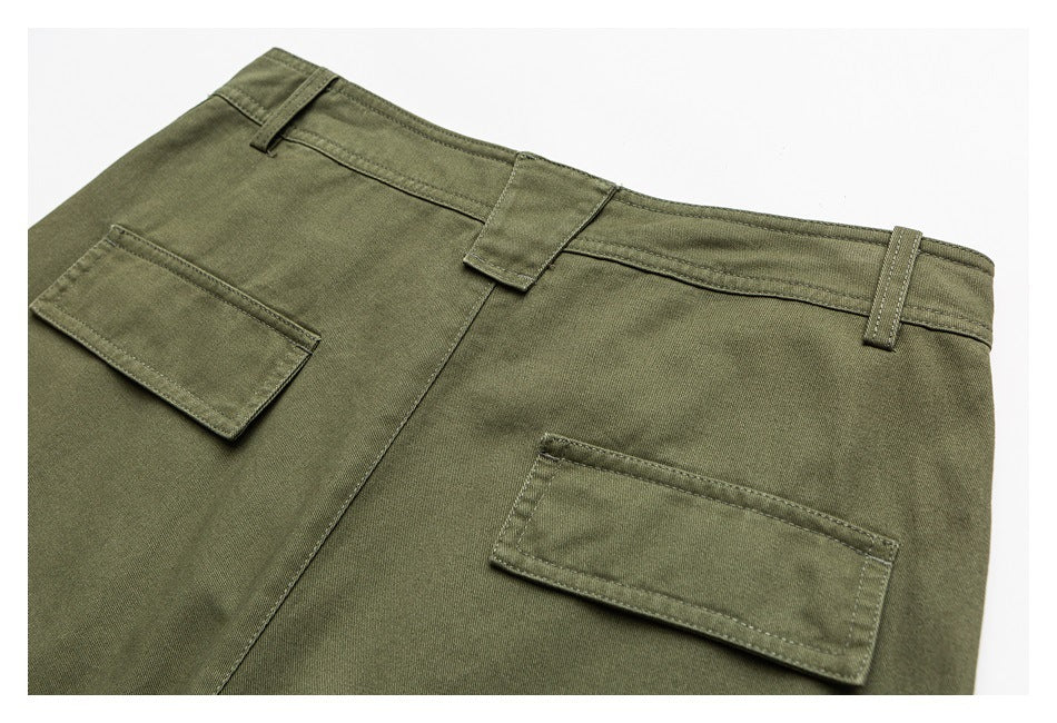 Close-up of the back of olive-green trousers, showing the waistband, belt loops, and two rectangular pockets.
