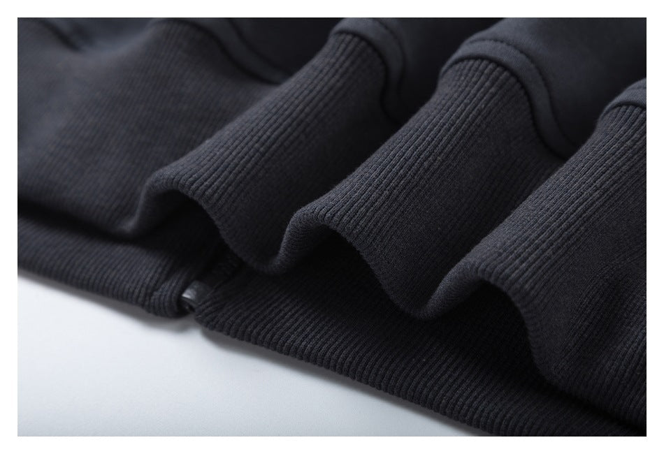 Close-up of ribbed trim on a dark charcoal garment.