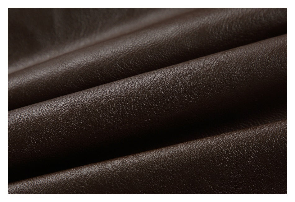 Macro view of dark brown pebbled material draped in soft folds.