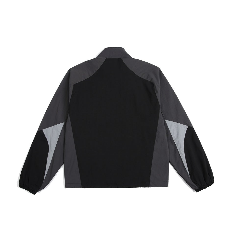 Back view of a color-block jacket in black, charcoal, and light gray, shown against a white background.