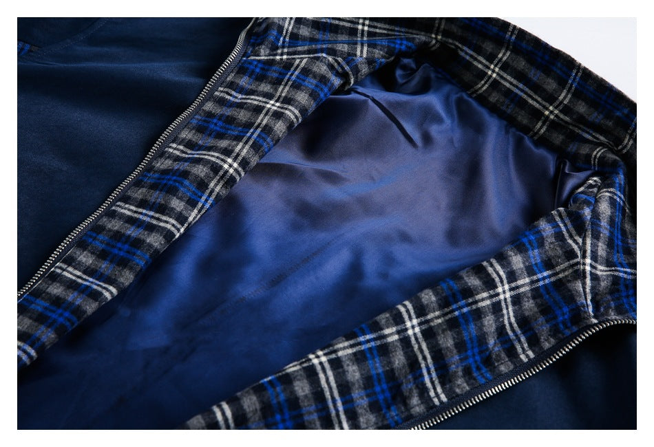 Open navy garment showing blue lining, plaid inner edging, and a metal zipper.