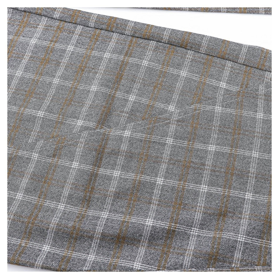 Close-up of the gray trousers' white and brown plaid pattern and stitching.