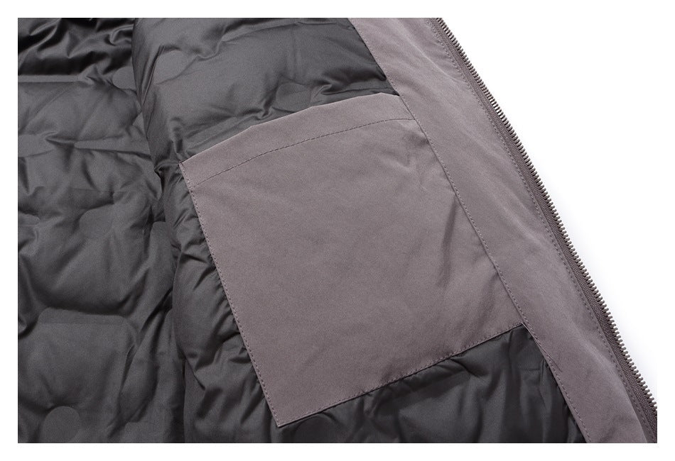Inside a gray jacket, showing a large rectangular pocket beside the zipper.