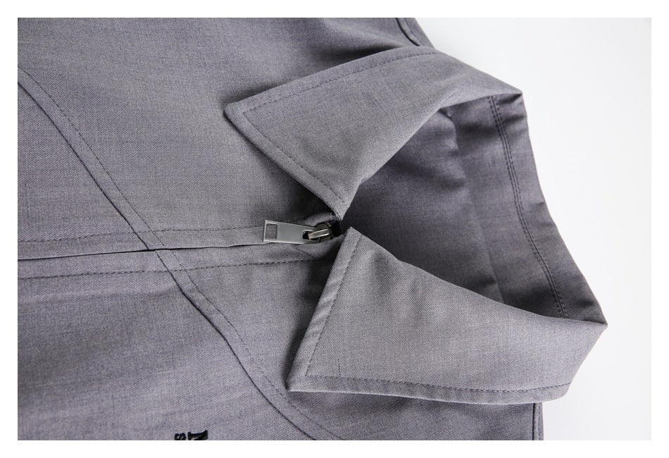 Close-up of a gray garment's folded collar and front zipper.