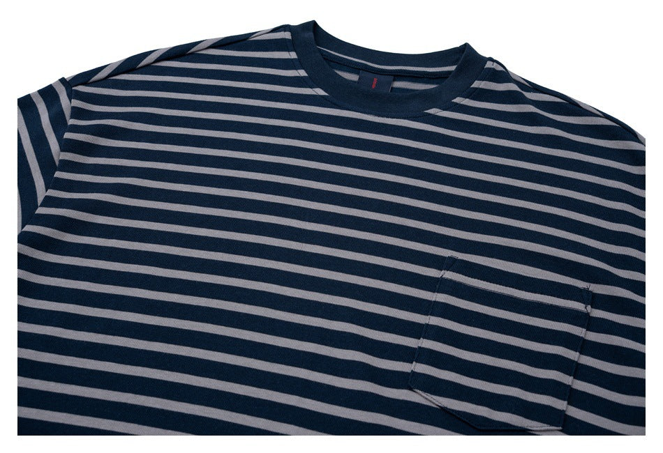 Close view of a navy and gray striped crew-neck T-shirt with a chest pocket.