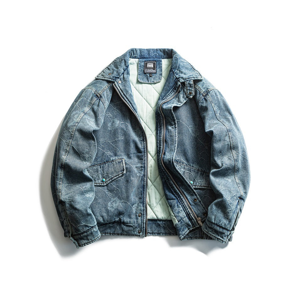 Blue floral washed denim jacket flat lay with zip open, showing light green diamond-quilted lining and flap pockets
