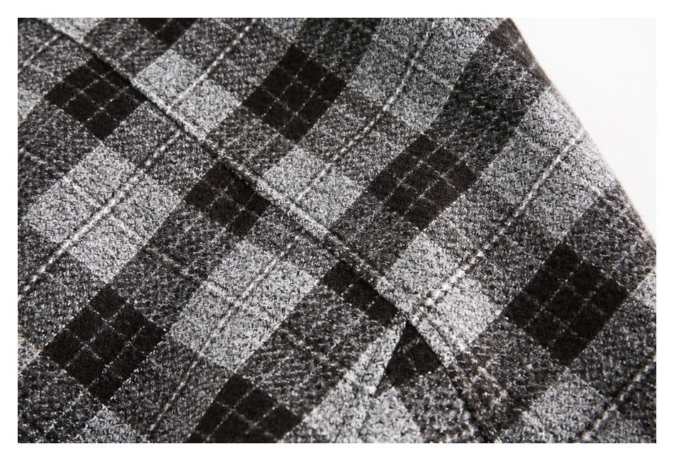 Close-up of seams and black-and-gray plaid fabric on a garment.