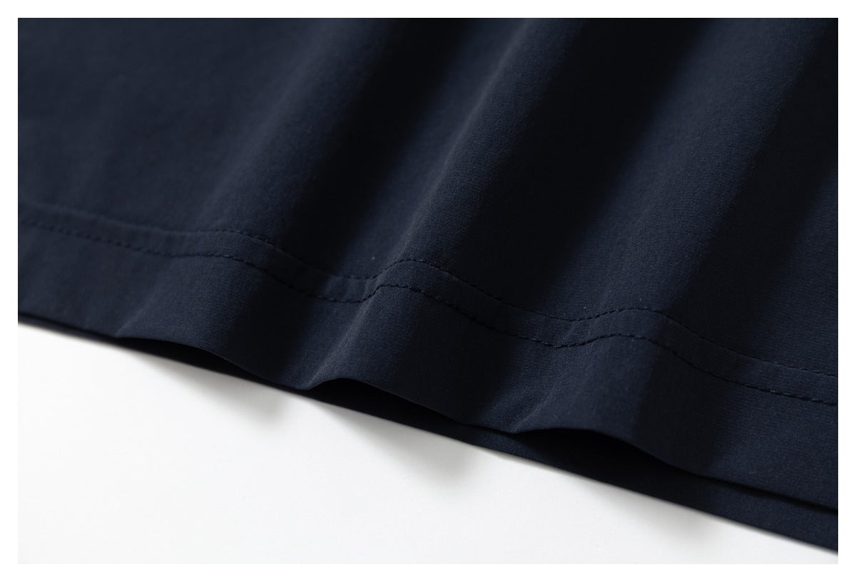Close-up of a dark navy garment hem with a visible stitched seam.