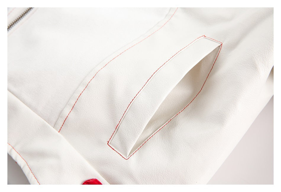 Close-up of a white jacket pocket with fine red stitching and a glimpse of a zipper.