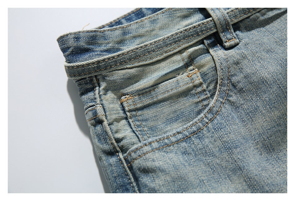 Close-up of the faded denim waistband and small front coin pocket with contrast stitching.