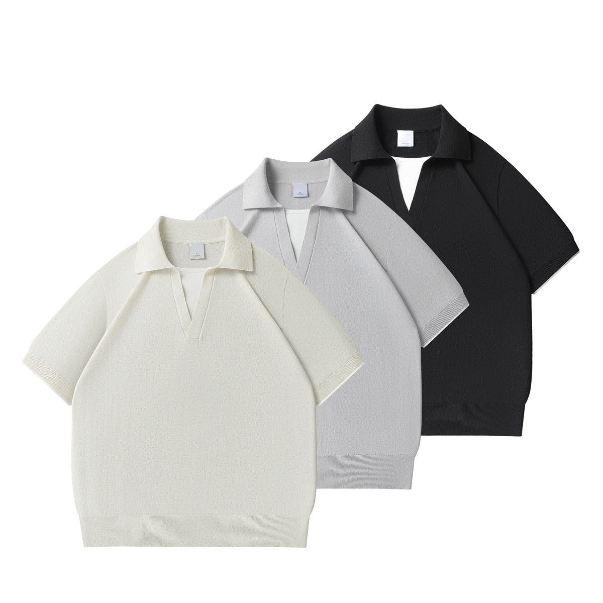 Three short-sleeve collared knit shirts arranged together in ivory, light gray, and black.