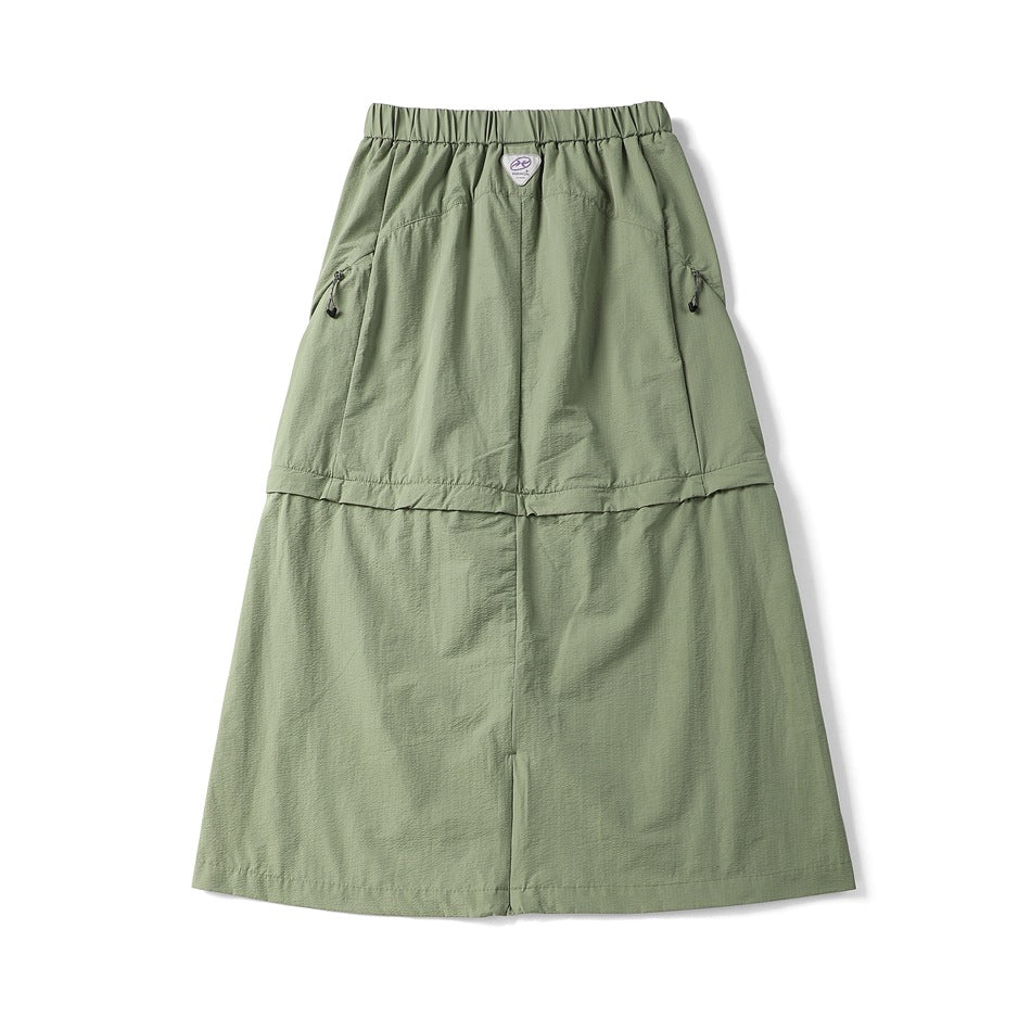 Sage green long skirt shown flat from the back, with an elastic waistband, zip pockets and a wide lower panel.