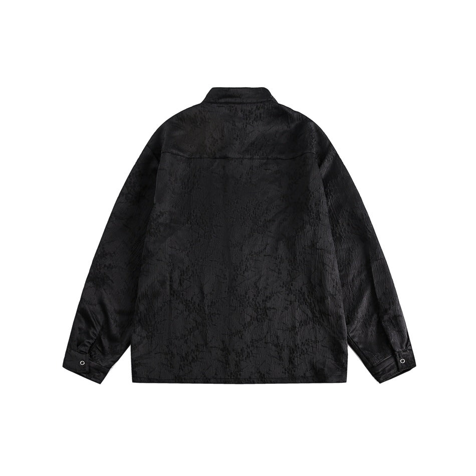 Back view of a black textured long-sleeve jacket with a stand collar and buttoned cuffs.