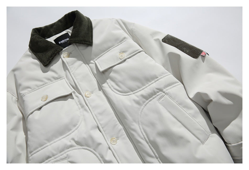 Angled close-up of the off-white jacket's corduroy collar, buttoned chest pockets, and sleeve patch.