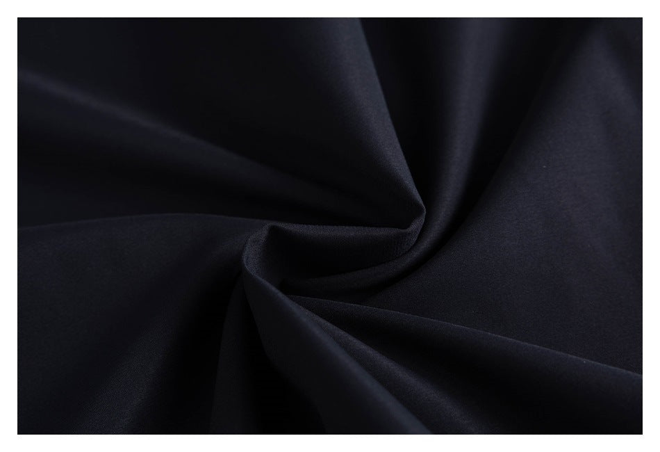 Close-up of dark navy fabric arranged in soft folds.