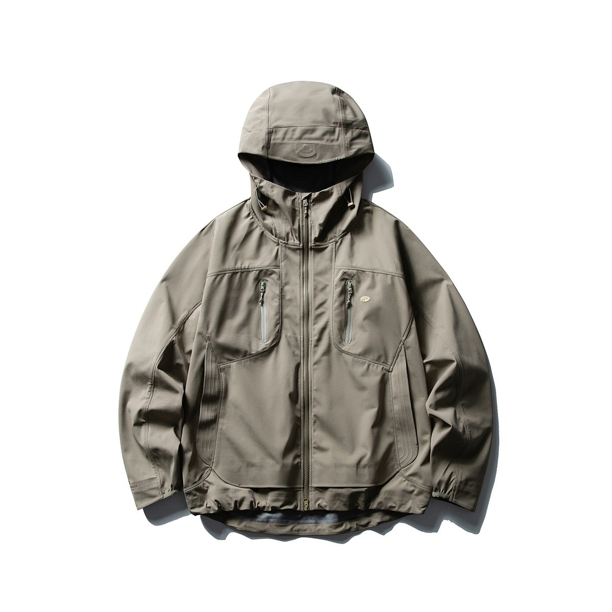 Khaki-taupe hooded zip jacket with zipped chest pockets, paneled sides and a curved layered hem, flat lay