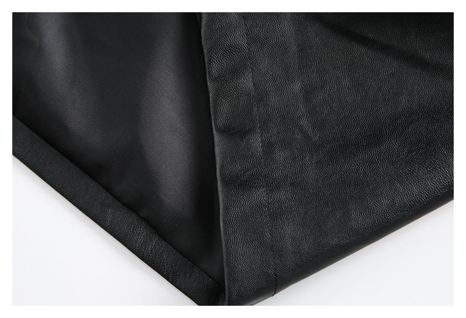 Close-up of black jacket material, showing a pebbled outer surface and smooth inner panel.