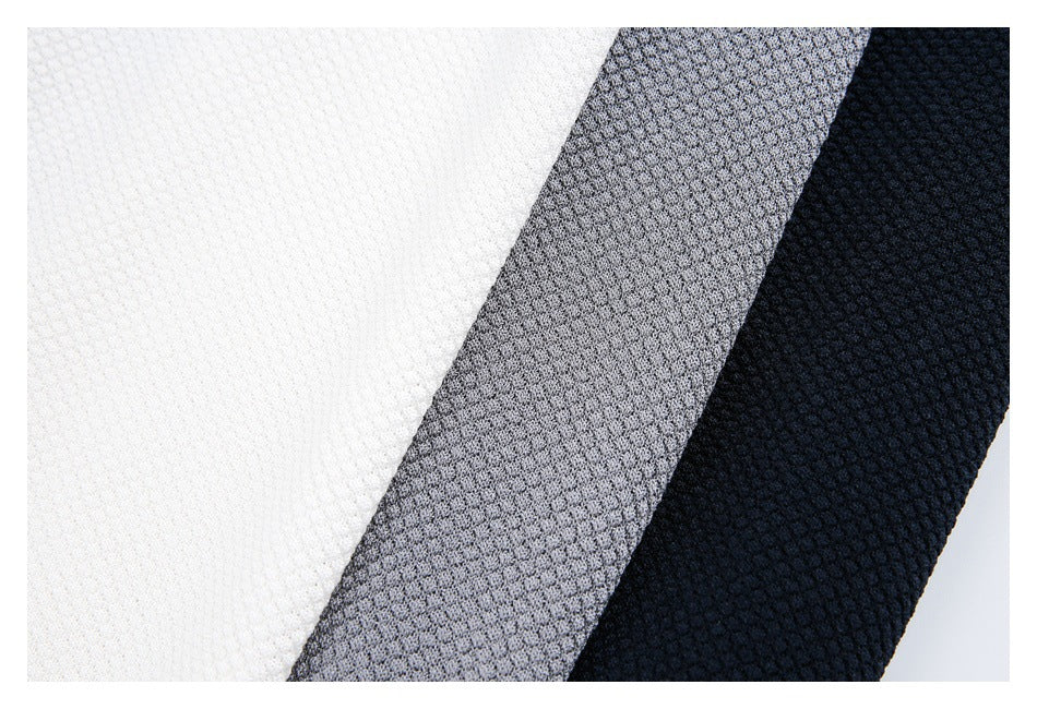 Close-up of textured polo fabric in white, gray, and navy colorways.