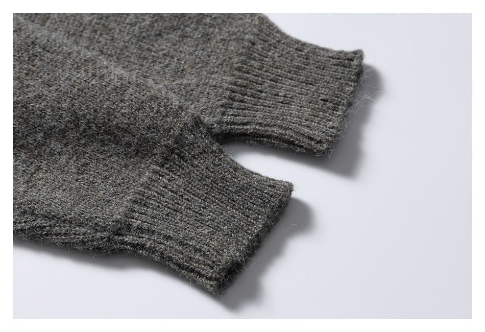 Close-up of two charcoal gray knit cardigan sleeves with ribbed cuffs.