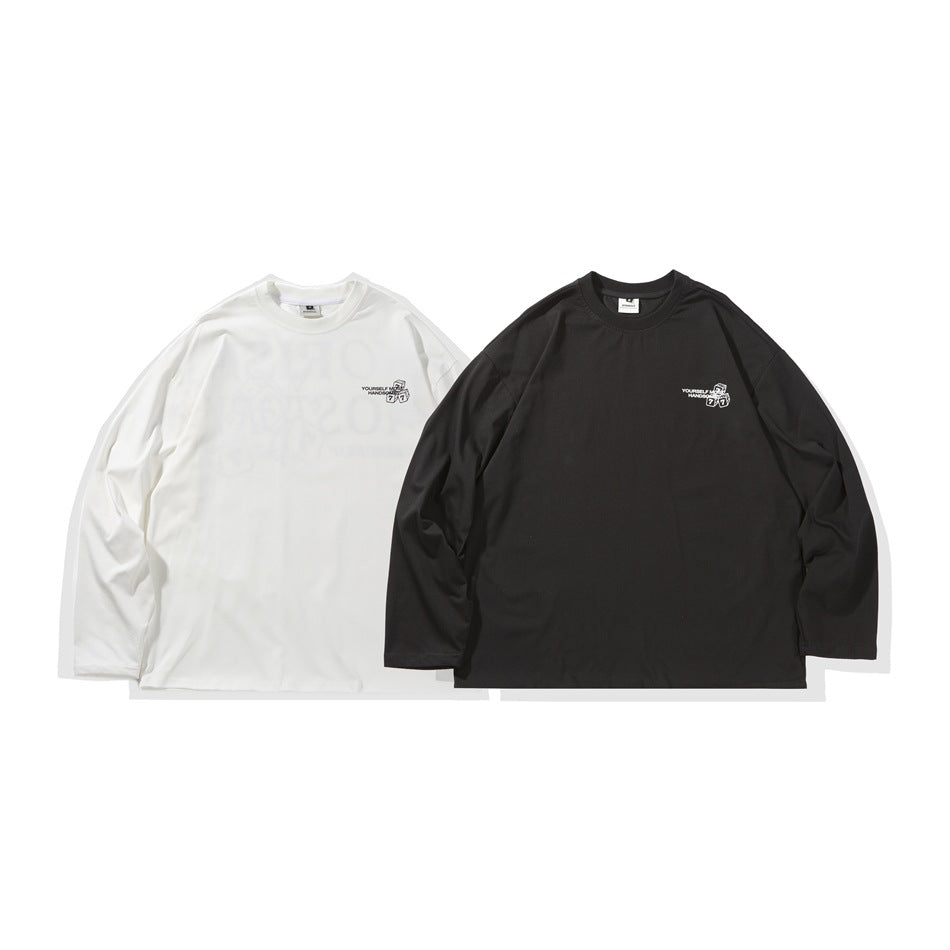 White and black long-sleeve shirts displayed side by side, each with a small chest graphic.