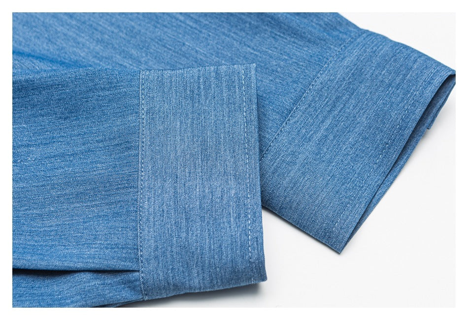 Close-up of the blue shirt’s long sleeve and wide button cuff with visible stitching.