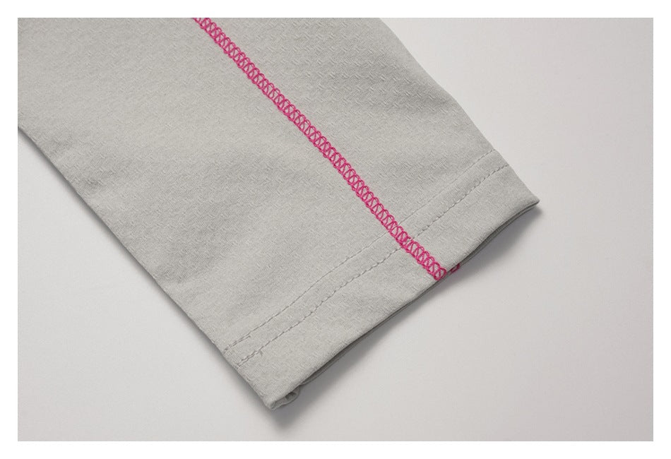 Close-up of a light gray sleeve cuff with pink overlock stitching along the sleeve seam.