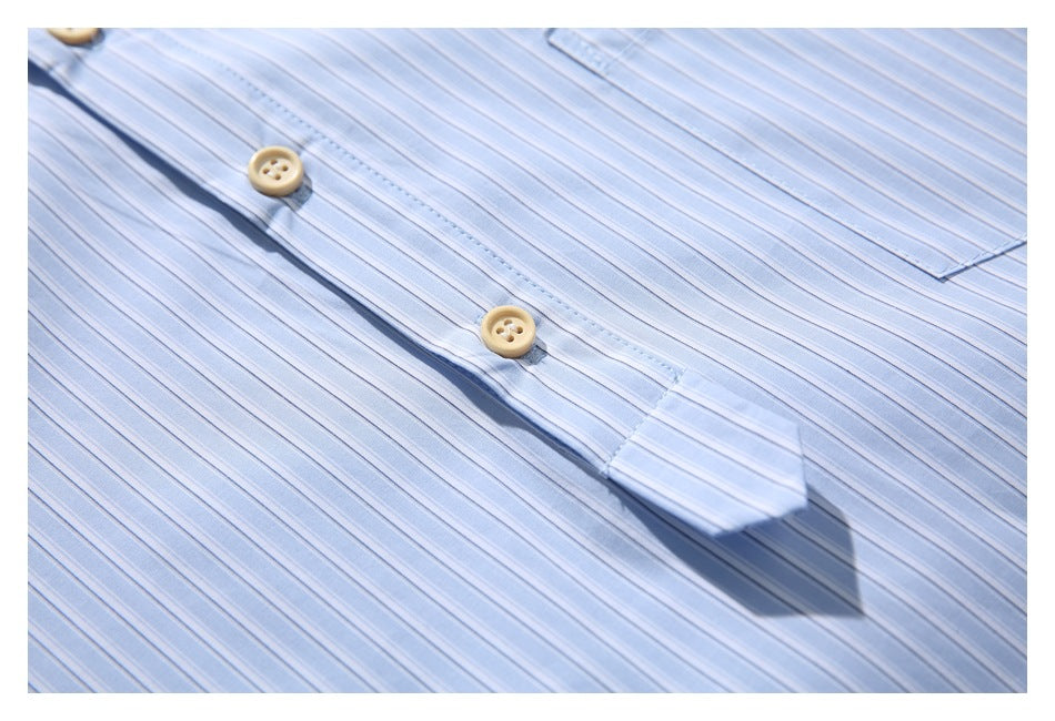 Close-up of a light blue striped shirt front with a button placket and pale buttons.