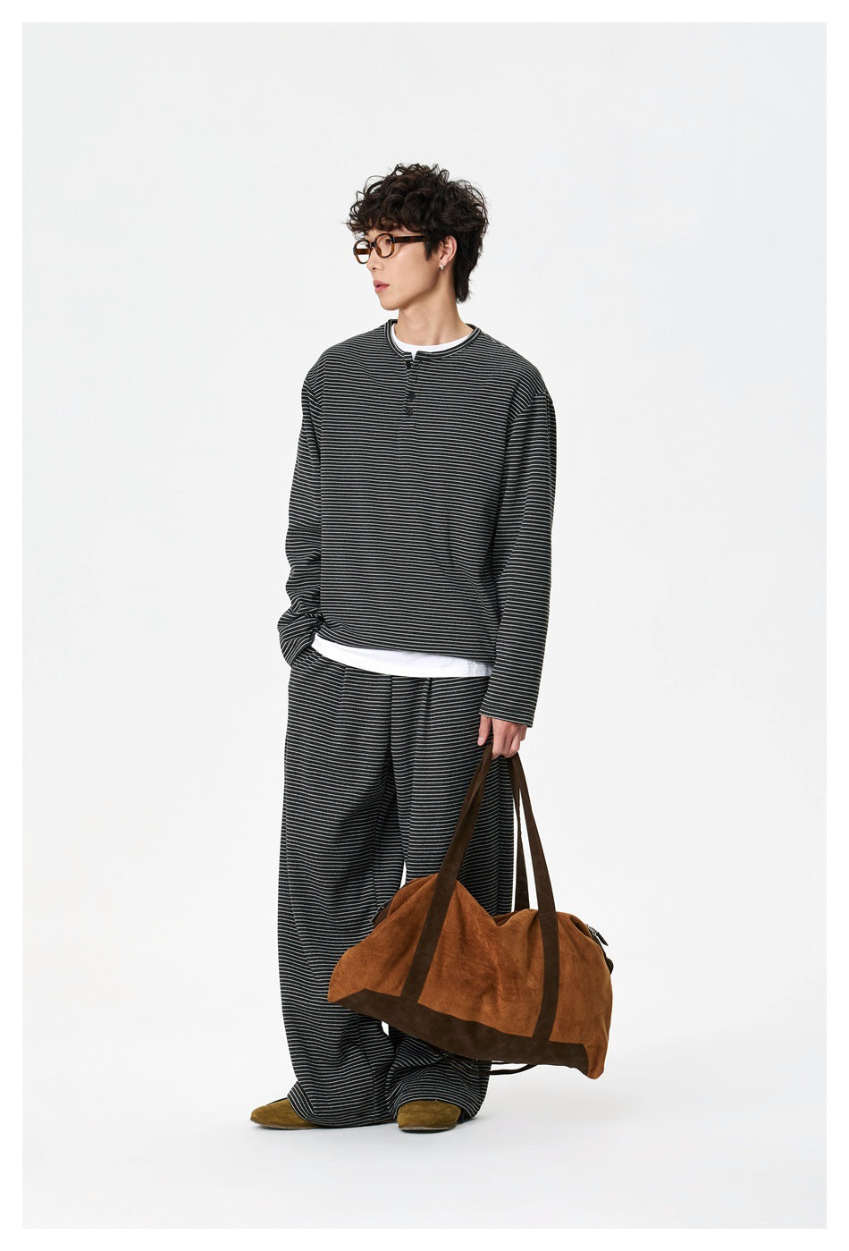 Model wearing a charcoal thin-striped long-sleeve henley and matching wide-leg pants.