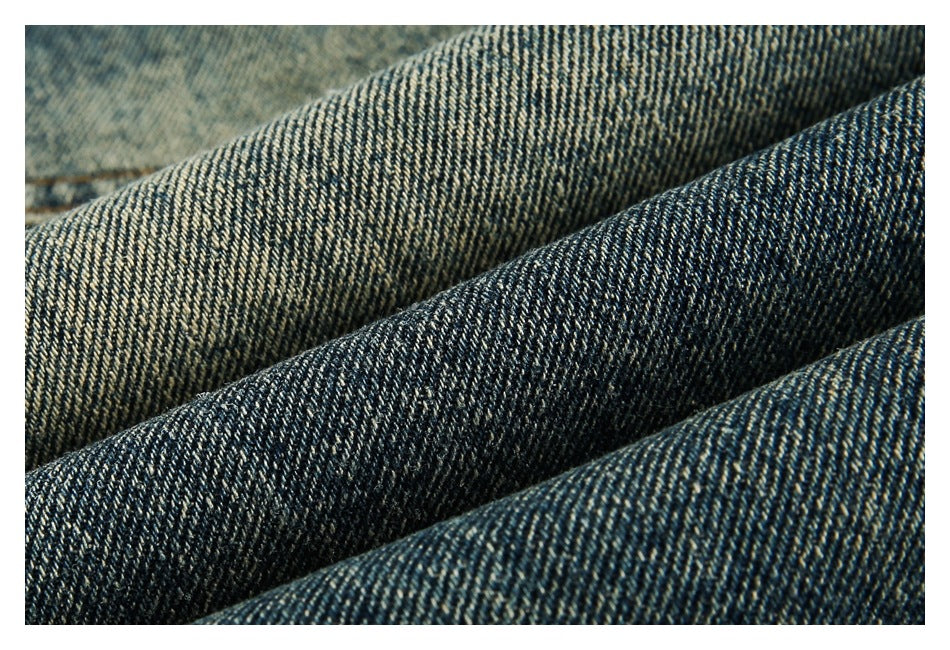 Macro view of the blue-and-tan diagonal weave in denim fabric.