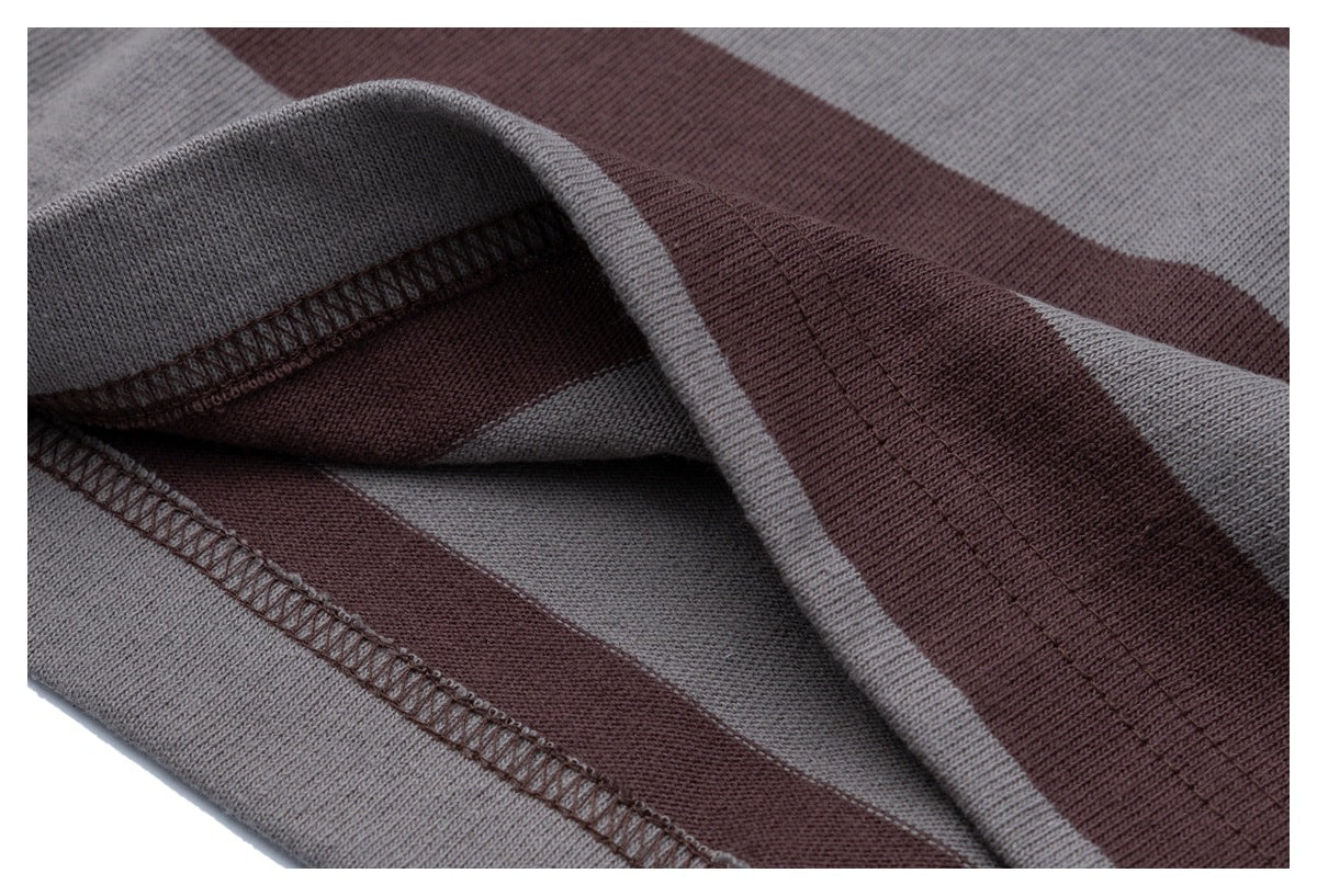 Close-up of the striped T-shirt fabric and stitched hem seam.