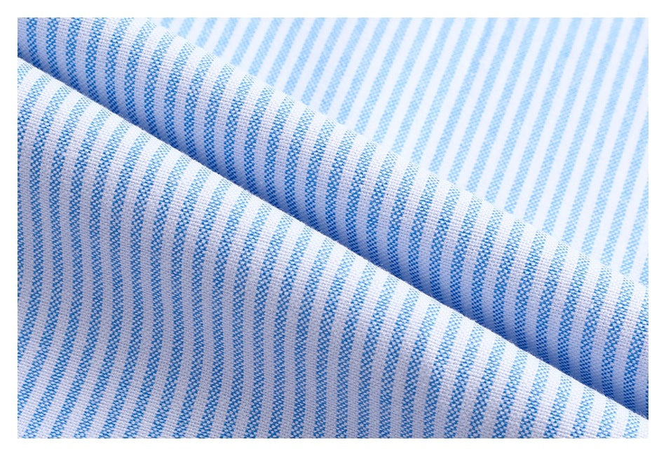 Close-up of white shirt fabric with narrow blue stripes, folded to show its woven texture.