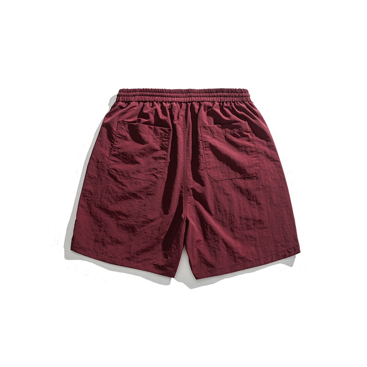 Burgundy shorts, flat lay back view, with elastic waistband and two patch pockets