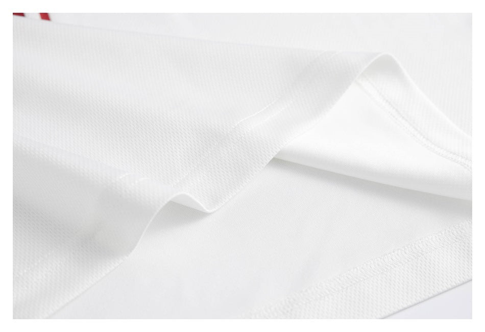 Close-up of white jersey fabric folds, seam stitching, and textured panels.