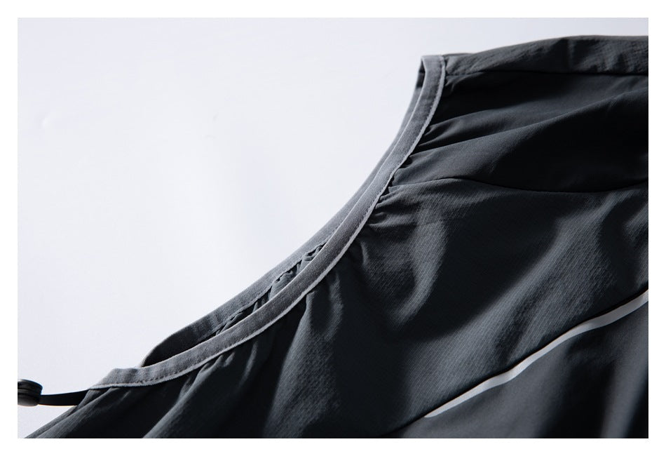 Close-up of charcoal jacket seam binding and a narrow reflective strip along the panel.