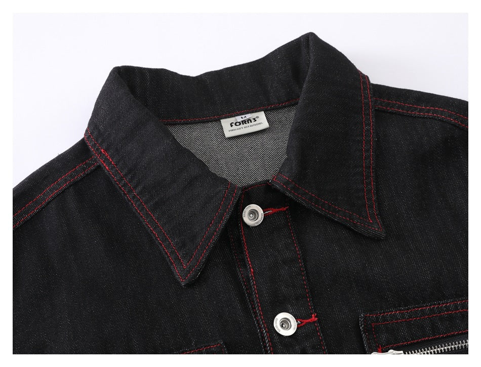 Close-up of the black jacket's pointed collar, red stitching, front buttons, and sewn-in neck label.