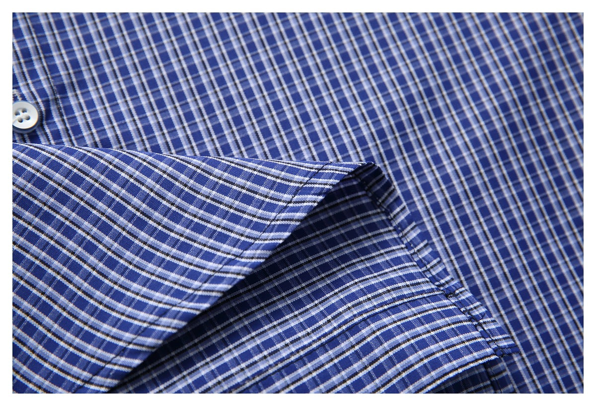 Close-up of a folded cuff on a blue-and-white checked shirt.