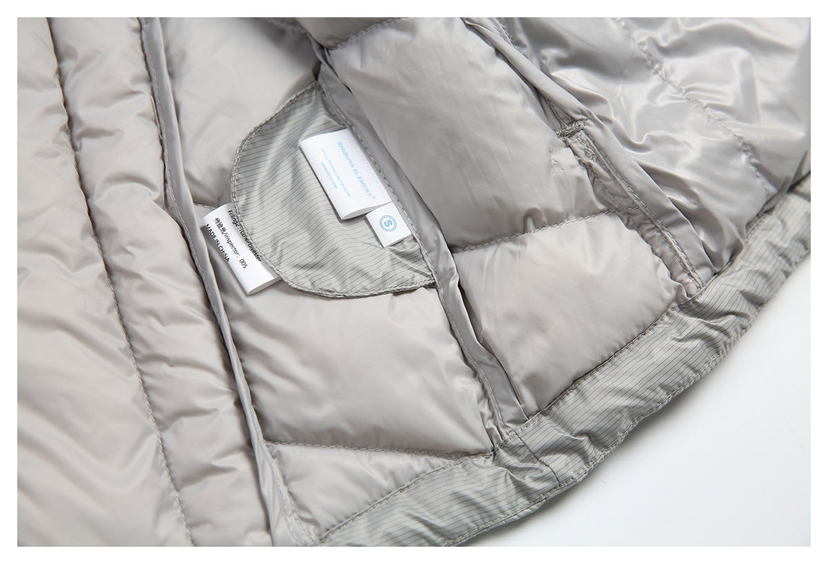 Close-up of a light gray quilted jacket lining with striped trim and sewn-in labels.