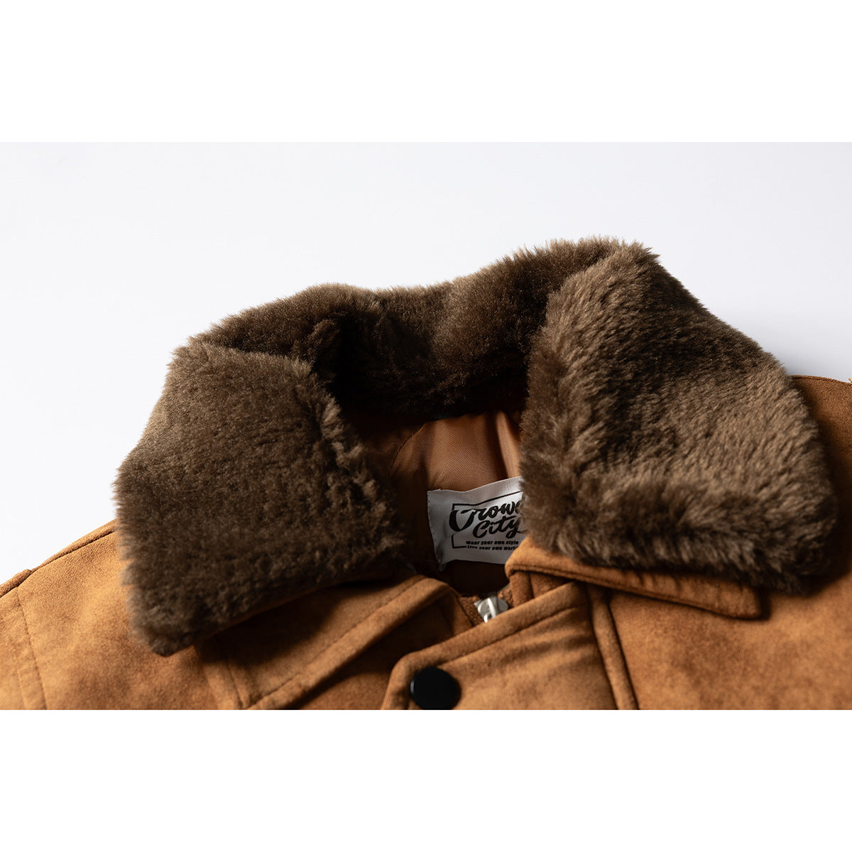 Close-up of the brown jacket's plush dark collar, inner lining, and sewn neck label.
