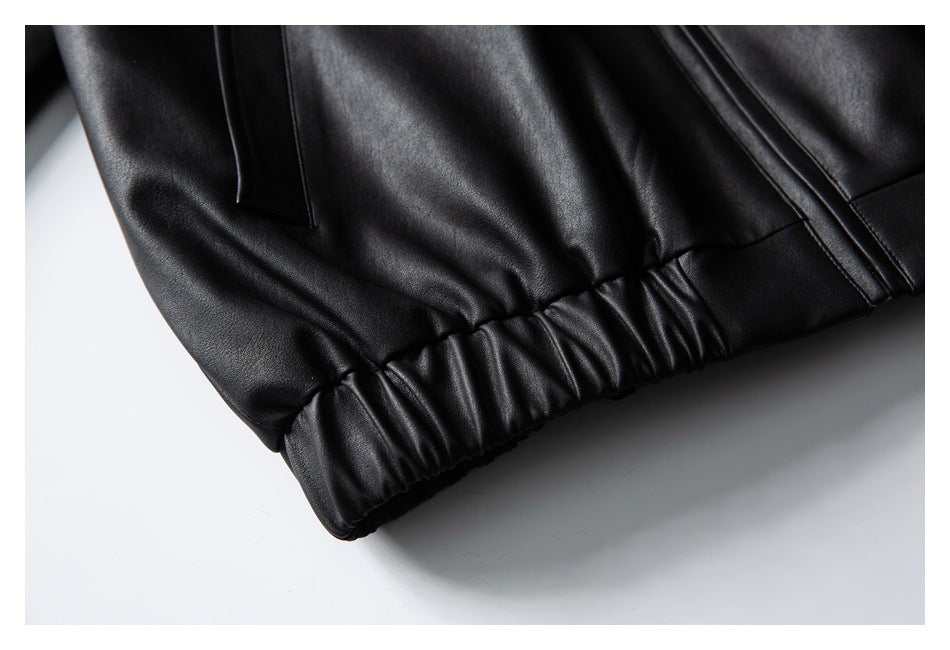 Close-up of a black jacket's gathered elastic hem and seam.