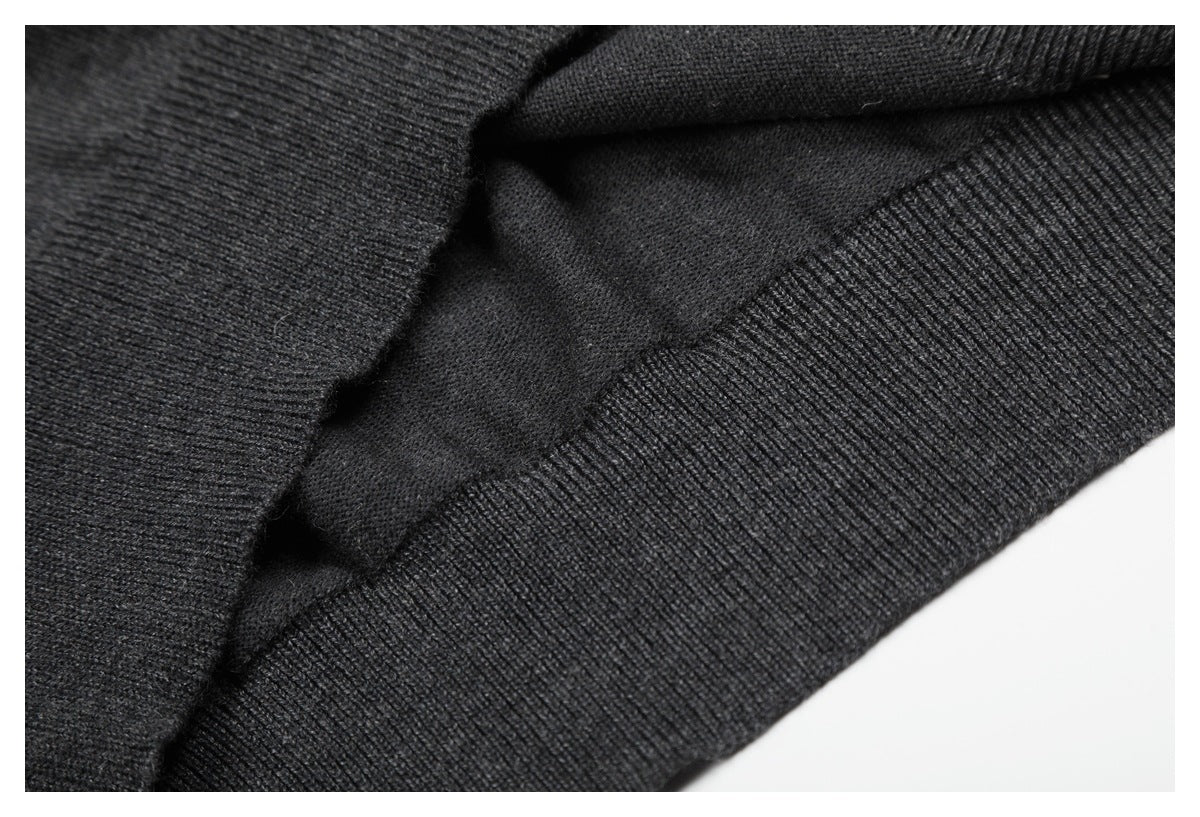 Close-up of the charcoal knit top's ribbed edge and inner knit surface.